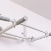 Pull up bars white atached to the wall.jpg